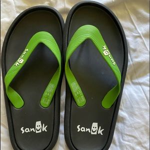 Bright green and black flip flops